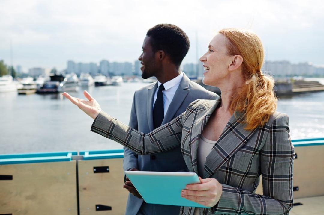 Two professionals talking at a marina